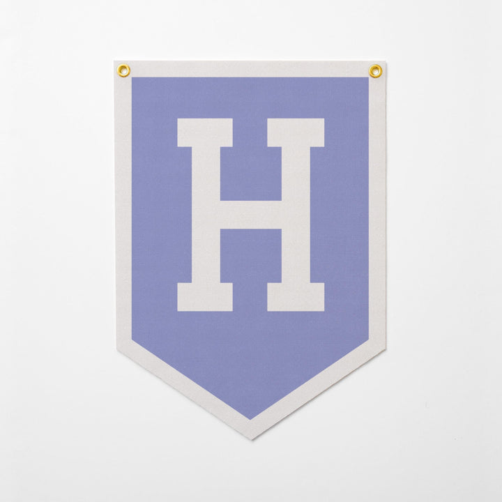 A banner with a large white letter &amp;quot;H&amp;quot; on a light blue background.