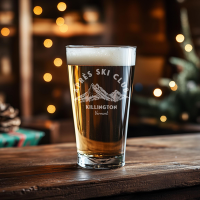 a glass of beer sitting on top of a wooden table