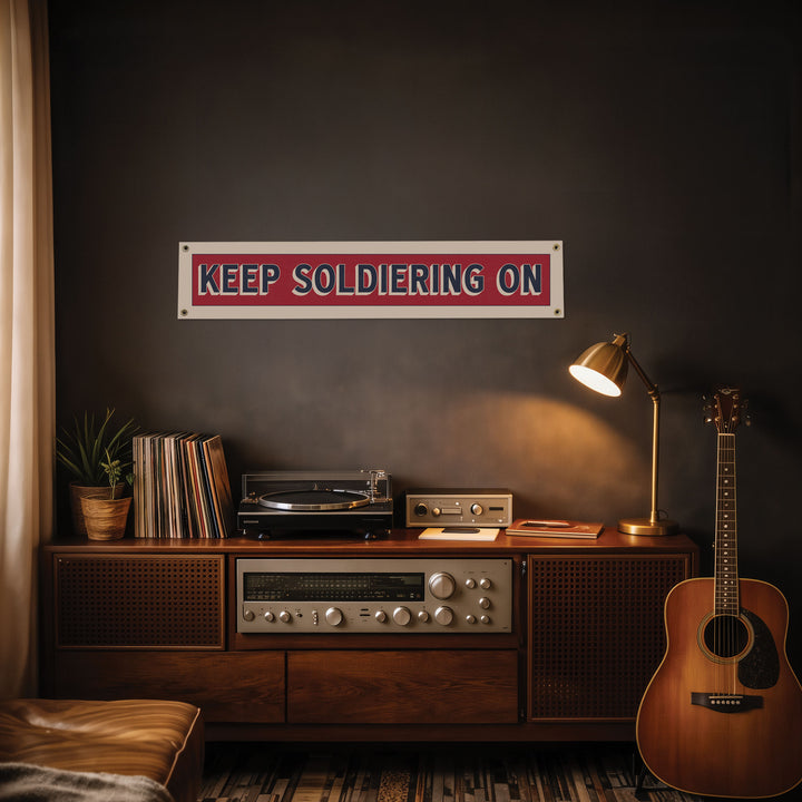 a wooden entertainment center with a record player, a lamp, and a guitar, along with a sign that reads "KEEP SOLDIERS ON".