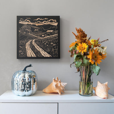 a vase of flowers sitting on top of a white dresser