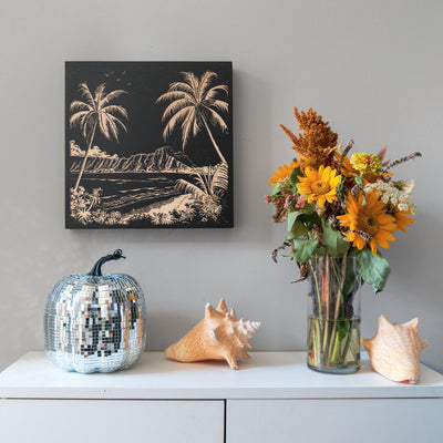 a vase of flowers sitting on top of a white dresser