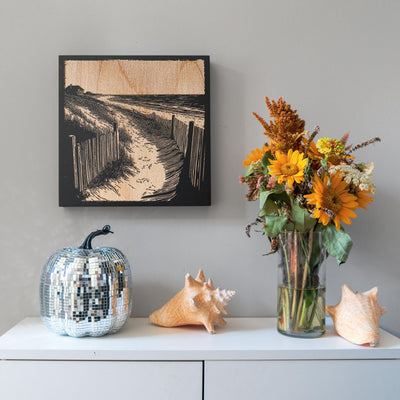 a vase of flowers sitting on top of a white dresser