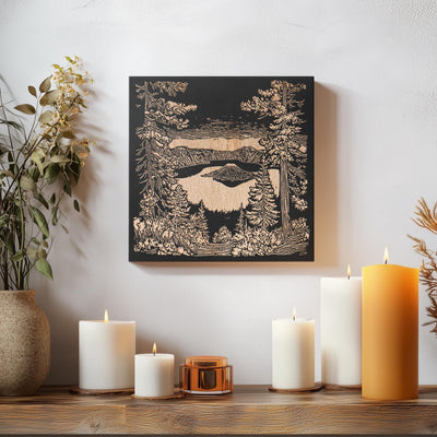 a table topped with candles and a painting on the wall