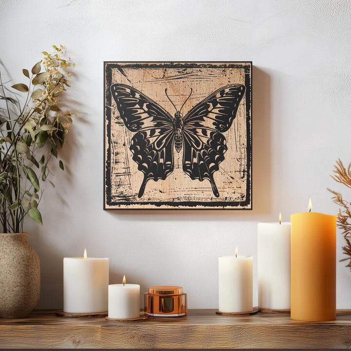 a picture of a butterfly on a wall next to candles