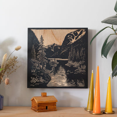 a picture of a mountain river in a wood frame