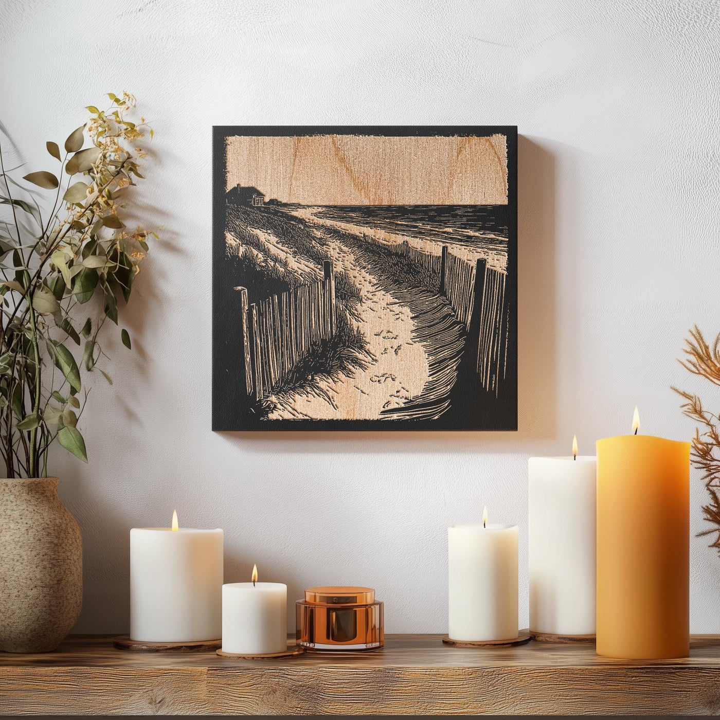 a wooden table topped with candles and a painting