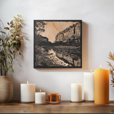 a wooden table topped with candles and a painting