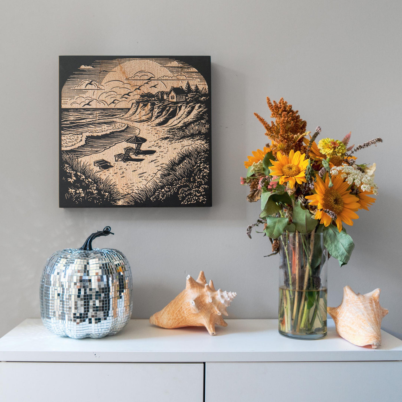 a vase of flowers sitting on top of a white dresser