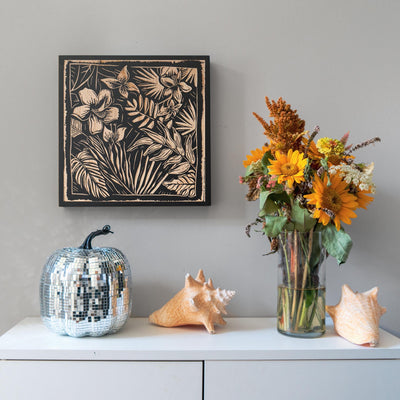 a vase of flowers sitting on top of a white dresser