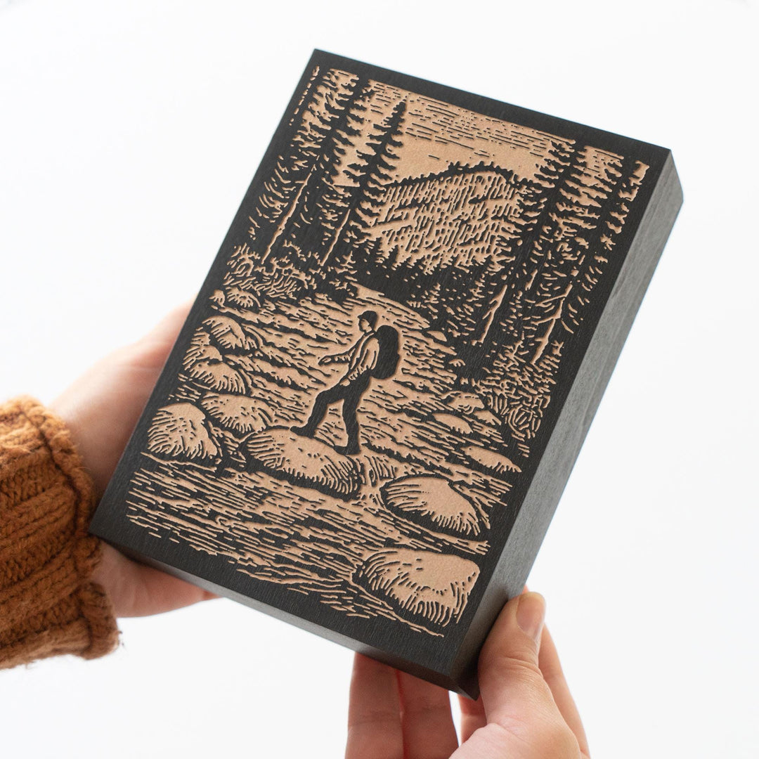 Hiker Crossing River Engraved Wood Panel